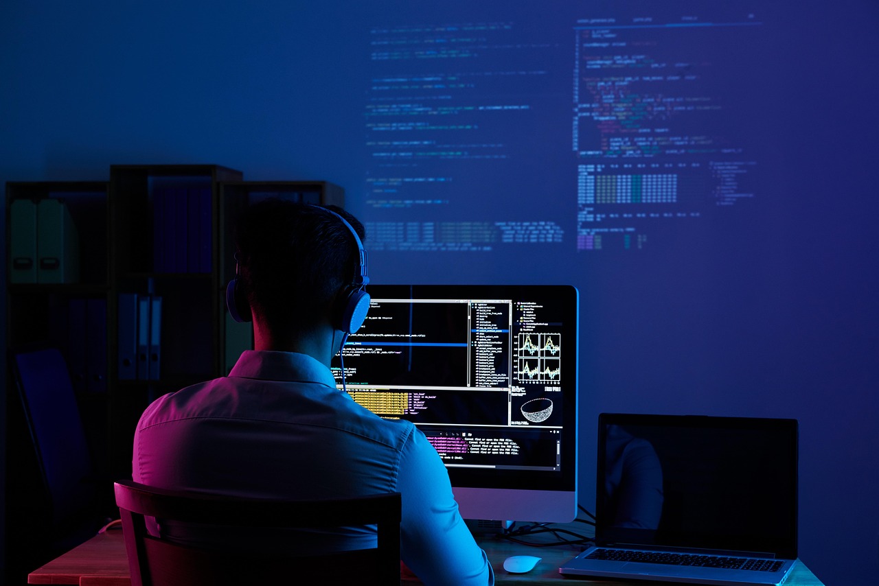 Developer working at a multi-monitor workstation