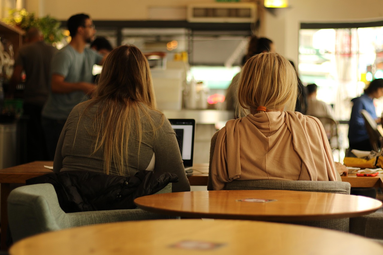 Two learners talking over a laptop