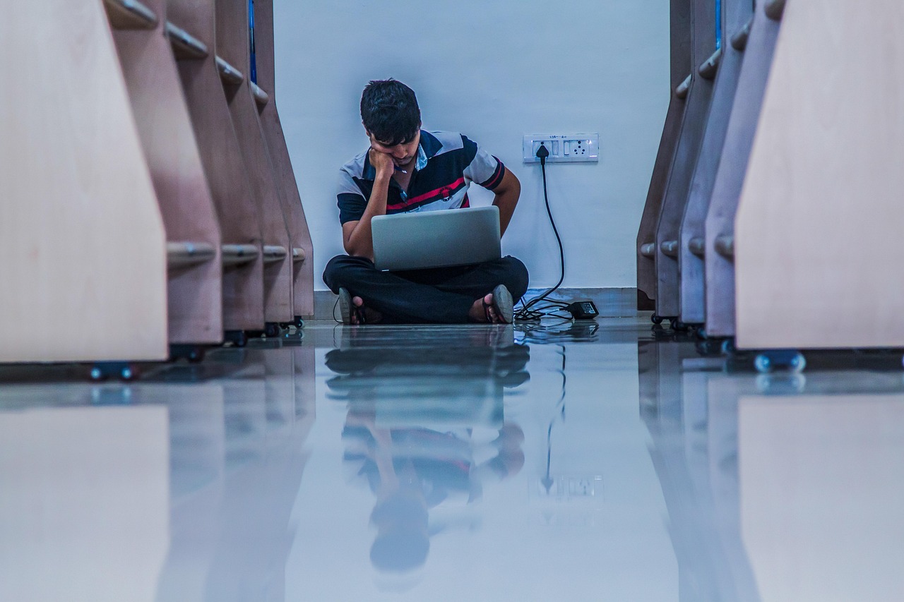 A learner focused on a laptop